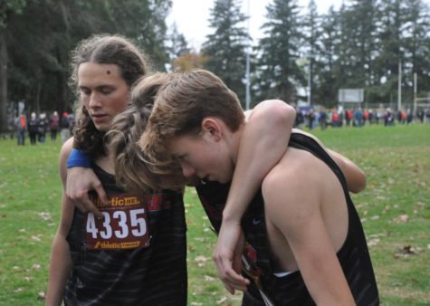 Quentin Stellpflug, 11, Raphael Blandini, 12, and Josh Hepner, 10, prepare for their race. They ran the top three fastest times for the team at districts this year. (Lane Shaffer)
