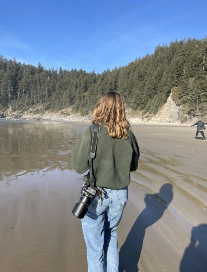 Lucy Gragg exploring the coast of Oregon. She looks for things to document with her camera.