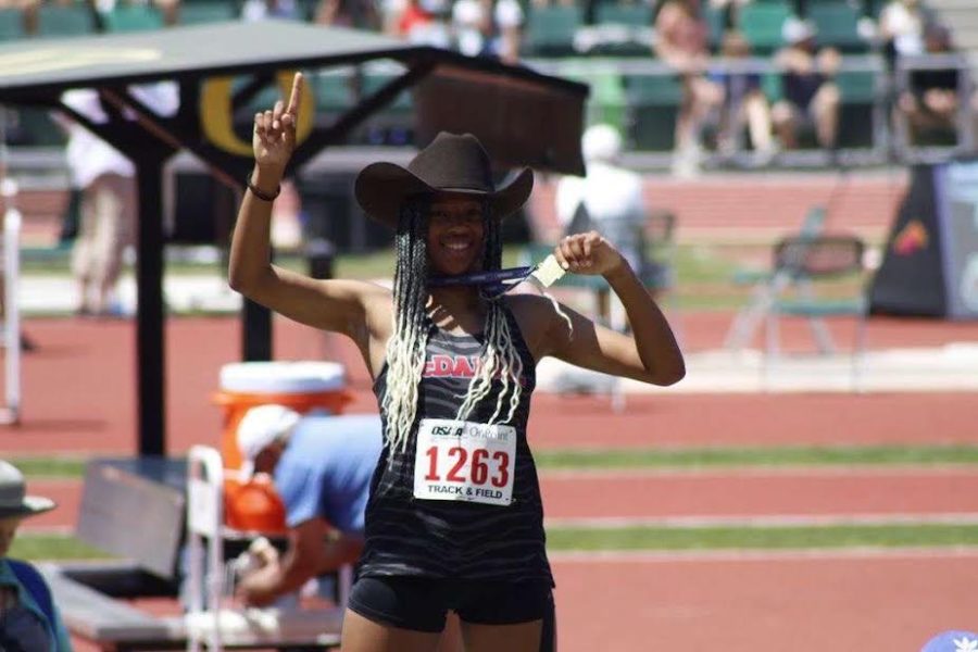 Junior Maleigha Canaday-Elliot posing at state after her triple jump event. Her jump secured a spot for nationals and tied a state record. (Photo courtesy of Artem Hoffman)