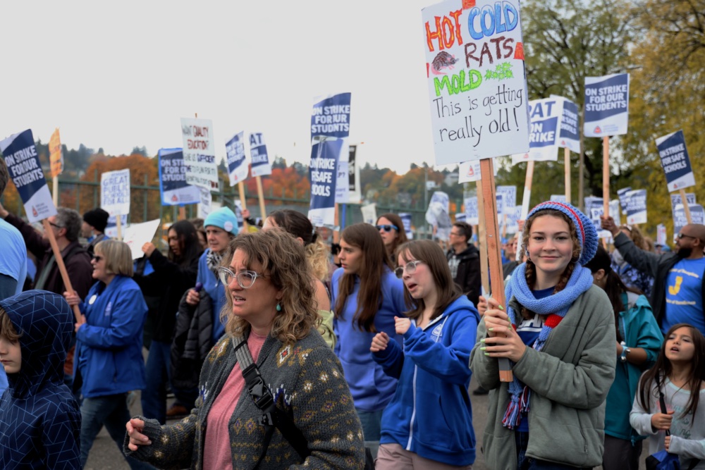 Students and parents come to support the PPS teacher union strike on Friday afternoon. They can be seen cheering and hoisting up signs to show their support for their local teachers. 