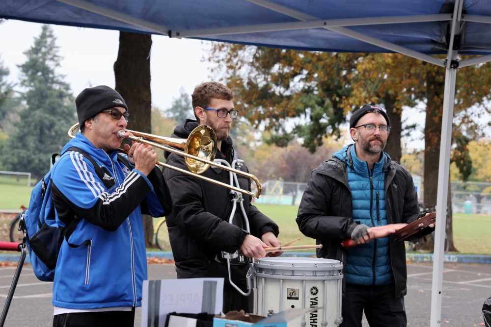 English teacher Gene Brunak on the trombone, band teacher Jeremy Dell on the marching snare and substitute teacher Dustin Starke on the tambourine stand next to one of the food tents located behind the strike. Alongside Josh Stohl, they play music to motivate the rest of the strikers. 