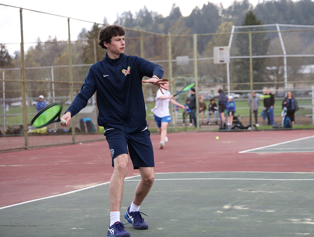 Varsity tennis captain senior Von Butenschoen, prepares to swing at an oncoming tennis ball. Butenschoen joined the team his freshman year and now holds the position of captain
