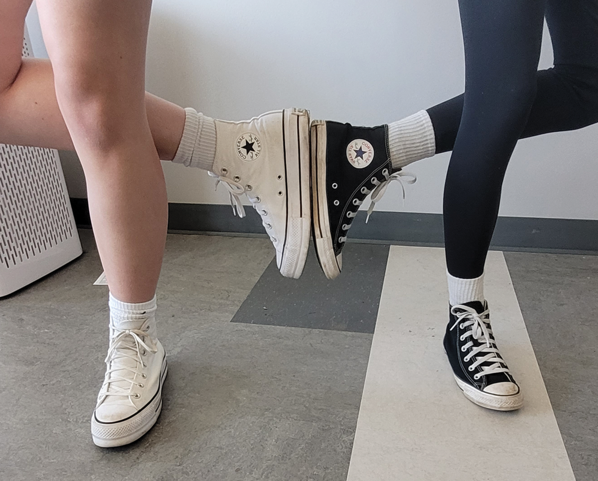Freshmen Lucy Anderson and Ava Wilken pose in their Converse All Stars. The shoes are often praised for their durability and widespread appeal.
