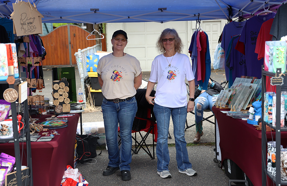 Margaret Owens (right) and Sher Kendell (left) smile while standing next to each other inside their booth at the Belmont Street Fair. They own a part time company called Dye Dreamers, which focuses on selling things such as crafting gifts, 3D prints, freeze dried candies, sublimation t-shirts and a wide variety of other items that you will soon be able to find at Dyedreamers.com. Owens mentioned how they enjoy getting to meet their customers and the steady yet busy flow of the fair. The Belmont Street Fair happens annually on the second Saturday of September from 10 a.m. to 5 p.m., stretching from SE 33rd Street to SE 39th Street. 