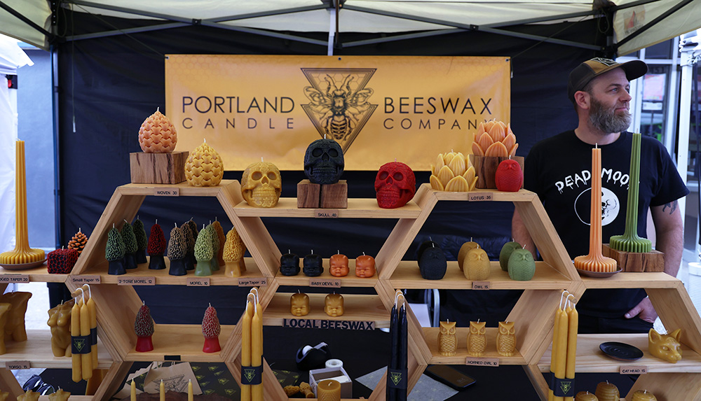 Aaron Fratis stands behind a large display of candles presented by the Portland Beeswax Candle Company. Fratis mentioned how he likes the dogs that people bring to the fair. “Everyone’s showing up, and it seems like everyone is excited to be here,” Fratis said. He smiles gently towards customers approaching the booth, extending a warm welcome. 