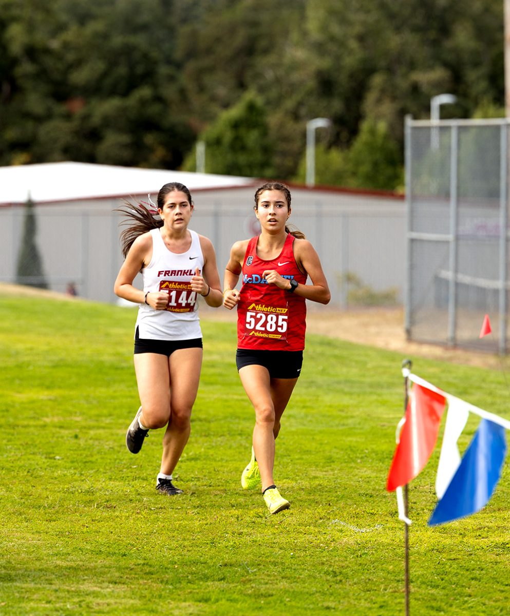 Senior Berlin Herrera cuts in front of Franklin. She is determined during the third lap of this race.