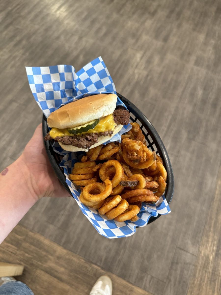 Single patty burger with signature curly fries located at Wolf's Head Burger's and Malts.