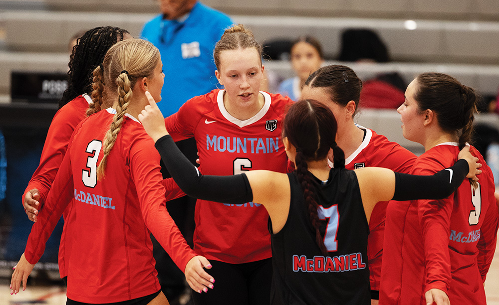 Junior setter Lily Mae-Buerkle leads a huddle during a volleyball game against McNary. She demonstrates her leadership skills as the Mountain Lions soared to a 3-2 victory. 