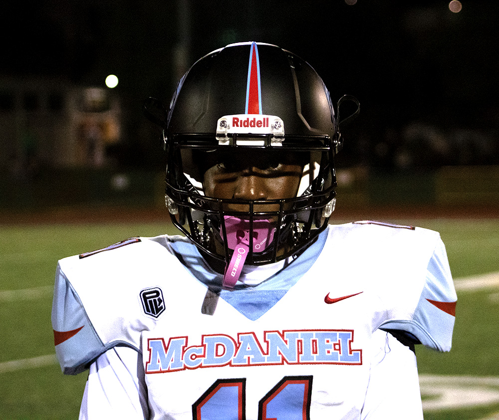 Defensive Back Princess Fletcher looks towards the camera in her football uniform at the McDaniel vs. Cleveland football game. Football is one of the three sports that Fletcher is participating  in her senior year.