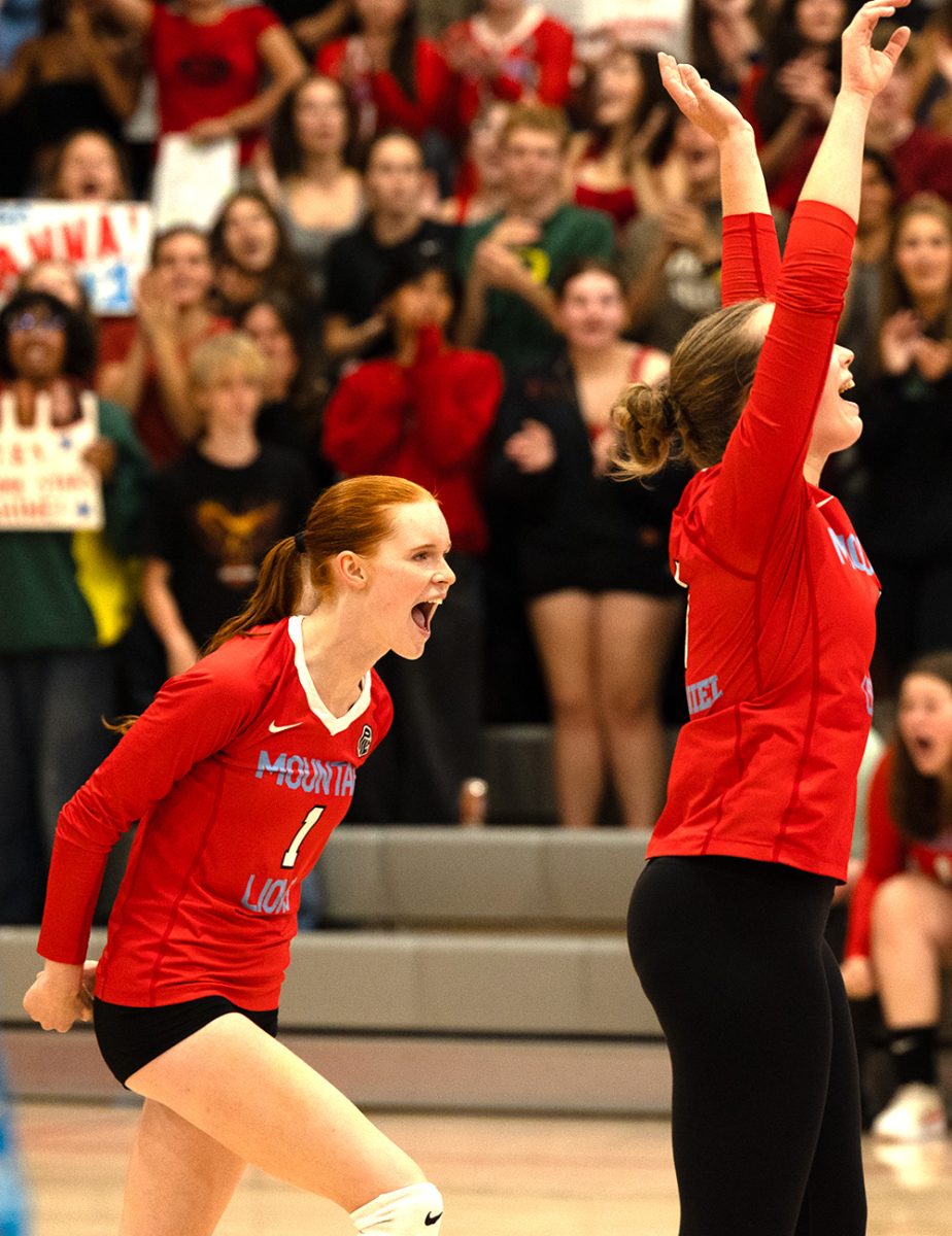 Captains Anna Gladwin and Lily Mae Buerkle cheer after the team won a point against McNary. The point seals the fate of their opponents, securing a victory in their first home game.