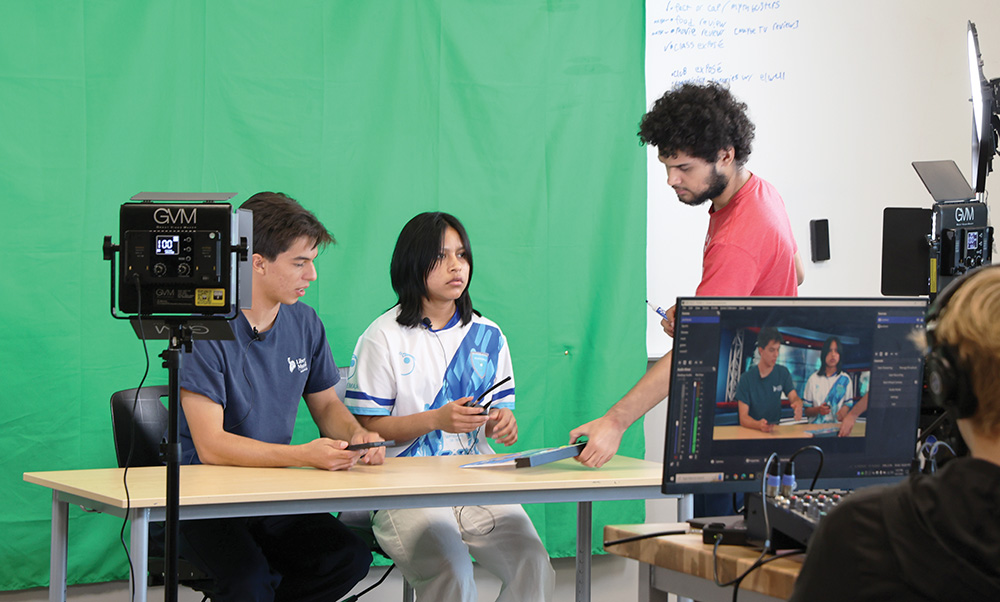 Senior class president Santana Apodaca, newcomer representative junior Lily Gutierrez Morales, and broadcast manager senior Joelliuz Andino read over the script for the announcements. The process is student-led and their hard work pays off over the course of the week.