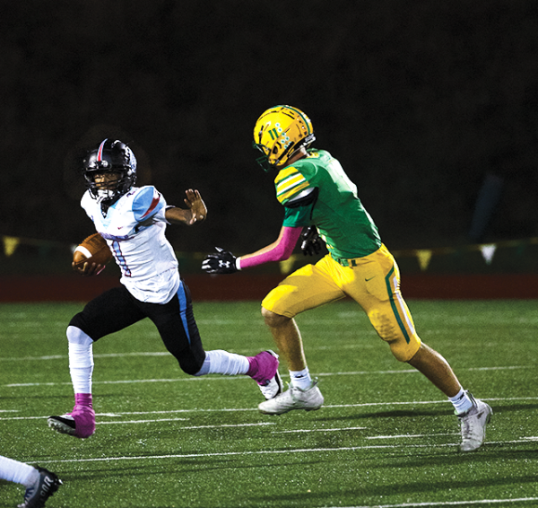 Junior Tre’Marion Crawford holds off the Cleveland defense as he runs the ball forward. The Cleveland defender chased him down. Crawford played a massive part in this big win completing 10 out of 17 passes and throwing for four touchdowns helping McDaniel seal their first win.