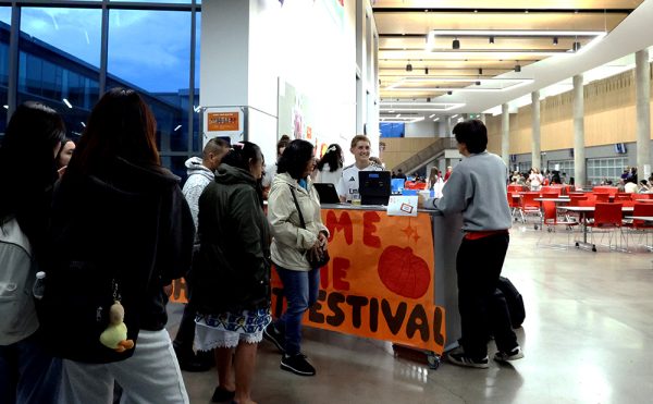 As people arrive, they buy their tickets to purchase goods at the festival. The festival focused on bringing not just students, but people from the community in as well. 