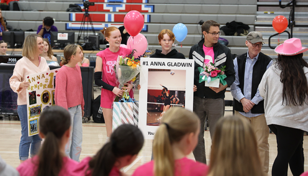 The only senior volleyball player Anna Gladwin gets speeches from her teammates on Senior Night on Oct. 17. Gladwin stands with her family embracing the moment.