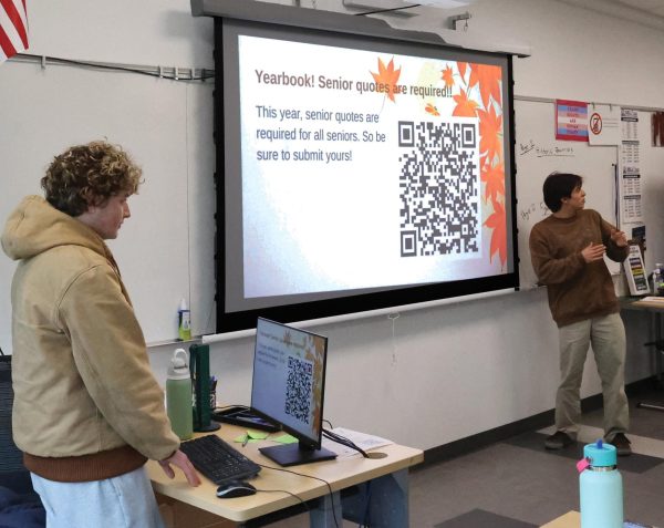 Senior class presidents Benny Wilson and Santana Apodaca present
a QR code to social studies teacher Michael Corenthal’s government
classroom. Wilson hopes that with this year, there will be a higher turnout
for senior quotes.