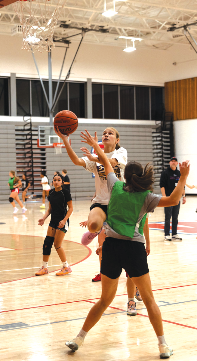 Sophomore Fiona Lillard leaps into the air.
She lays the ball into the basket and then gets back on defense.