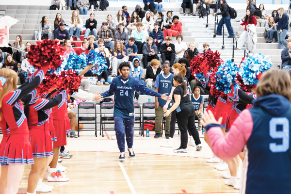 Junior Muhammad Mohammad through the clap line. The crowd cheers as his name gets announced.