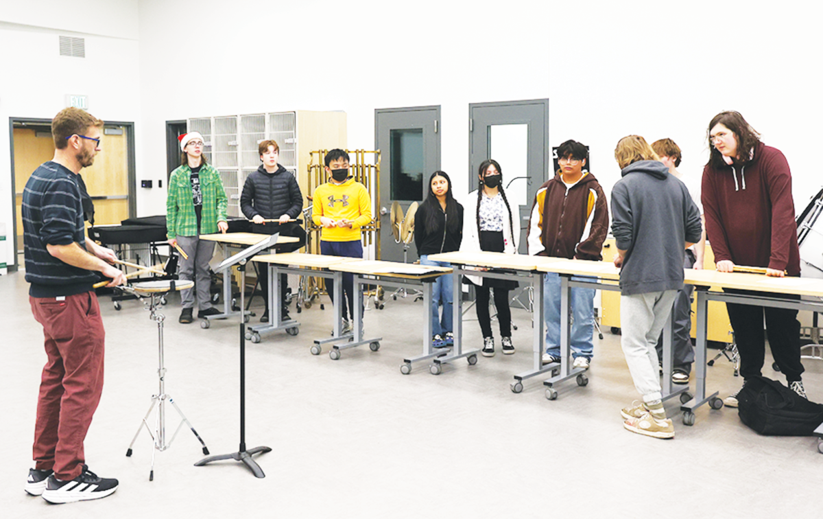 Dell works with band students during Drumline class. He and other students wish for more music classes offered in the future.