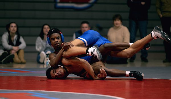 Senior Mohamed Fofanh pins his opponent. Fofanah would go on to win his match comfortably.