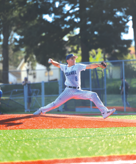 Junior Lowan Ouska jumps off the pitcher's mound. Ouska was the starting pitcher for the game against Franklin. He is set on striking out the batter and getting three outs to end the inning.