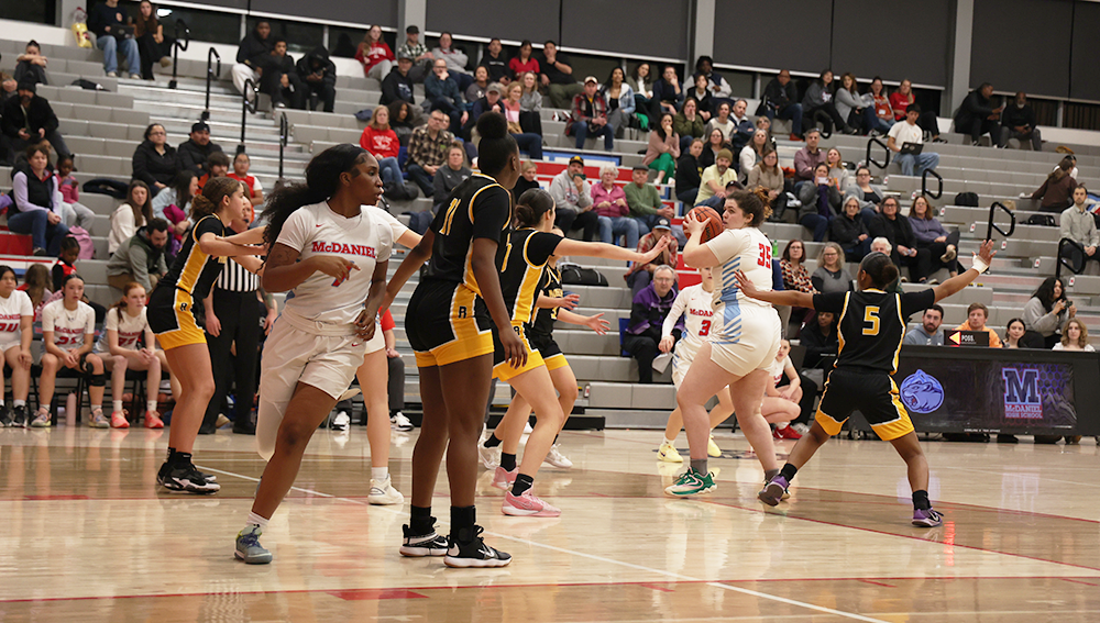 Senior Post Sadie Dearborn looks at senior guard Princess Fletcher, attempting to find a pass back out from the center for an easy layup. 