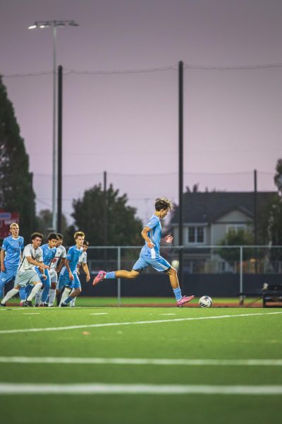 Sophomore Enzo Arias takes a free kick, resulting in a goal. McDaniel won 3-0 against South Albany.