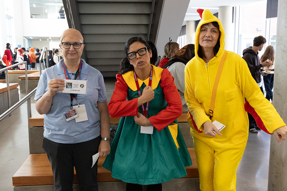 Physics and algebra teacher Andrea Leech, Vice Principal Keyla Santiago, and librarian Nancy Sullivan posing in their creative halloween costumes.