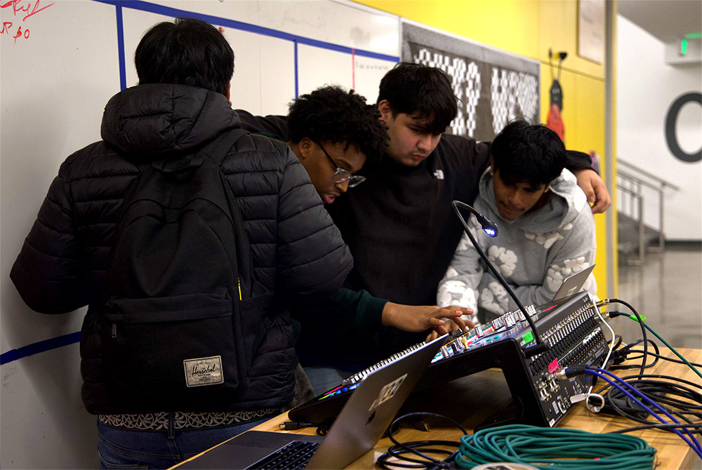 Advanced Audio Engineering students (from left to right) Andy Chaves Dolores, Abdi Ibrahim and Nick Kalivas-Perez run the sound board for this lunch concert. The concert was located by the Community Partners space.