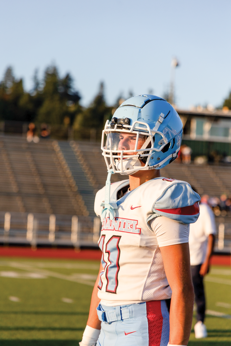 Freshman wide receiver Ian Herrera gets ready to take his position. The sun shines on him before the game against Wells.