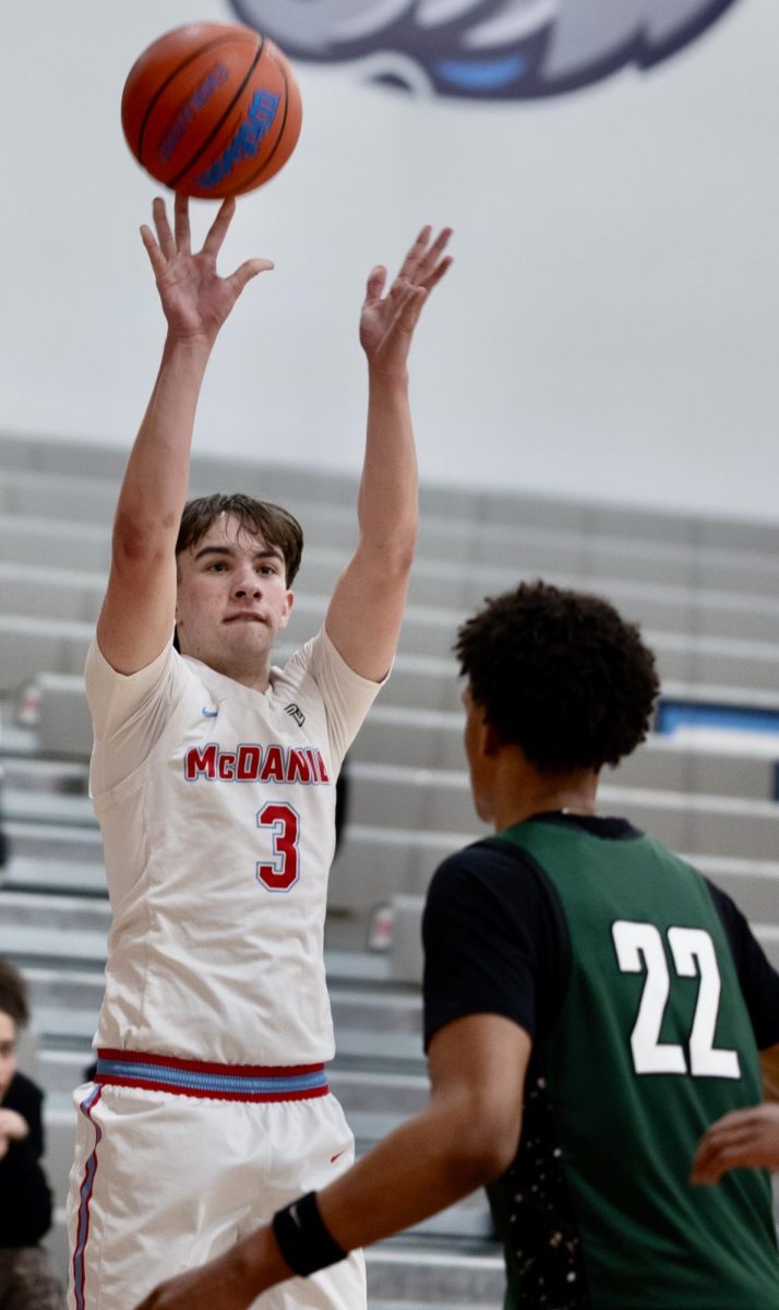 Senior Emmett Letson shoots a three-pointer in the first quarter, which he made. This is Letson’s first high school basketball season.

