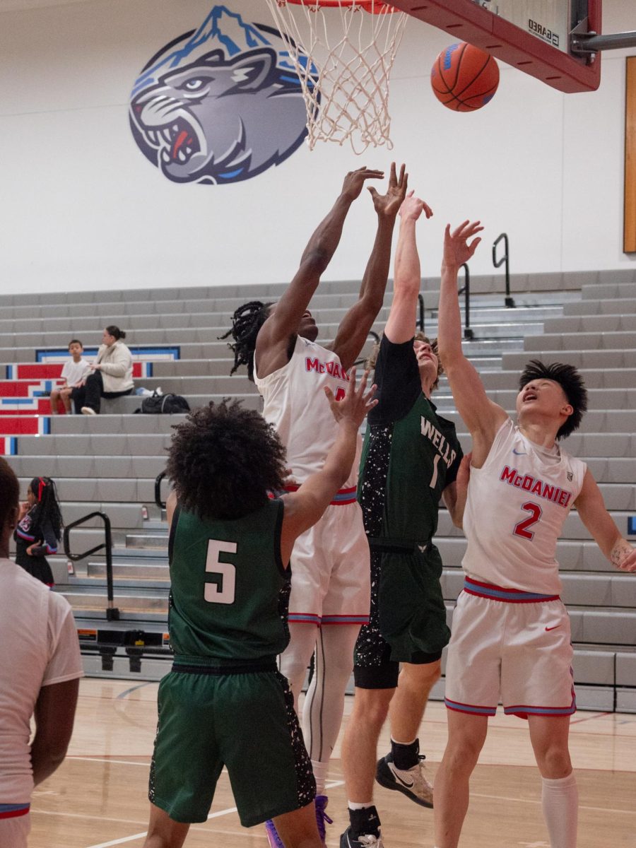 Senior Grant Fox and Zhu jump for an offensive rebound, trying to edge out two Wells seniors attempting to gain possession. Wells was able to get many buckets off of offensive rebounds, while McDaniel struggled to do the same.