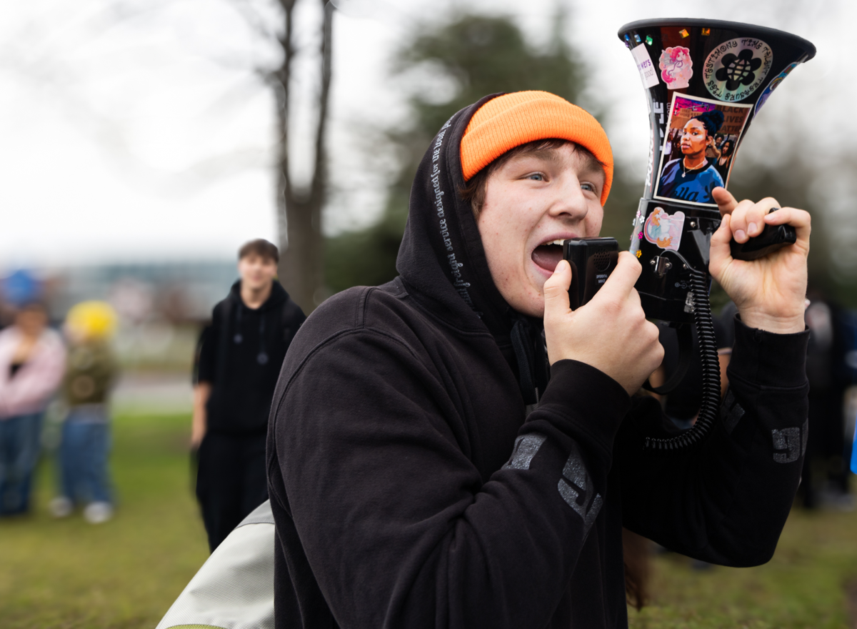 A student yells into a megaphone to direct the crowd. The protest drew hundreds of students out into the street.
