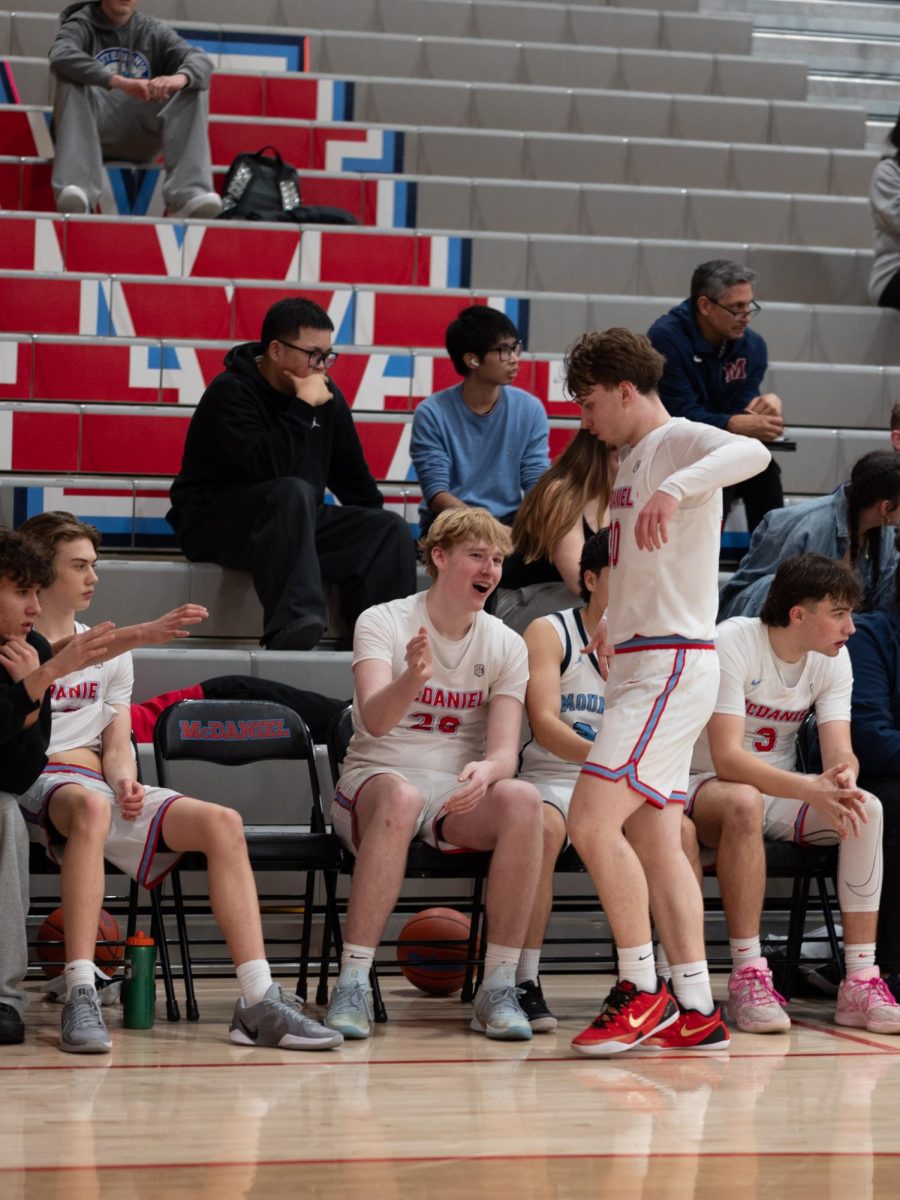 Sophomore Emmett Thompson gets congratulated while he returns to the bench. This is Thompson’s second year on varsity, and the only sophomore in their second varsity year.