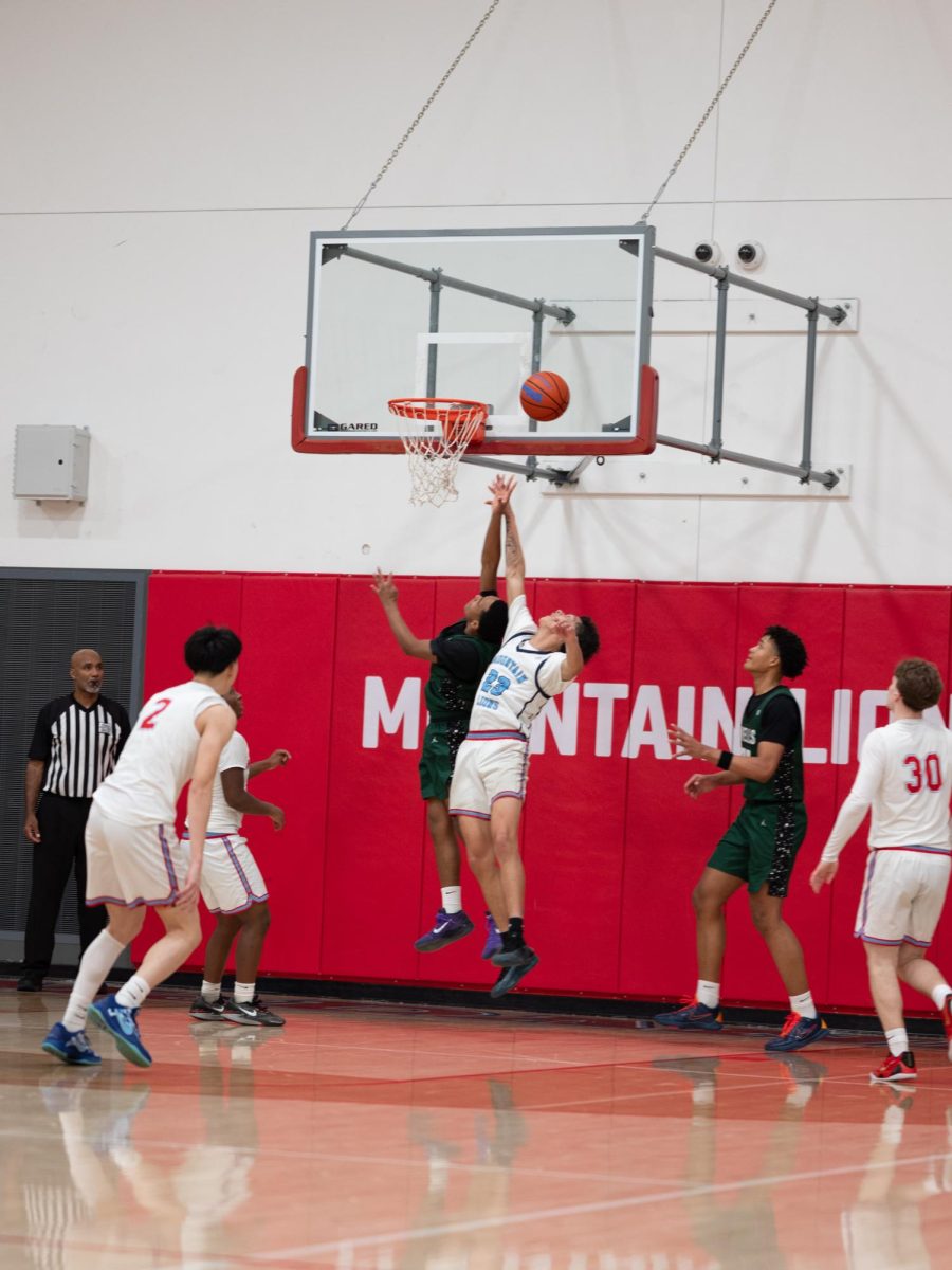 Robinson jumps on defense to reach the ball. The McDaniel defense loosened in the paint and the tall Wells team was able to get three dunks during the fourth quarter.