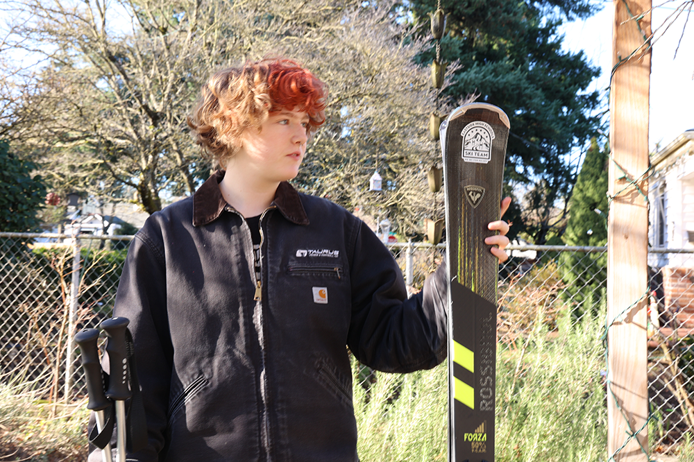 Sophomore ski team member Bee Naue poses with his gear. Naue describes training as difficult but rewarding.