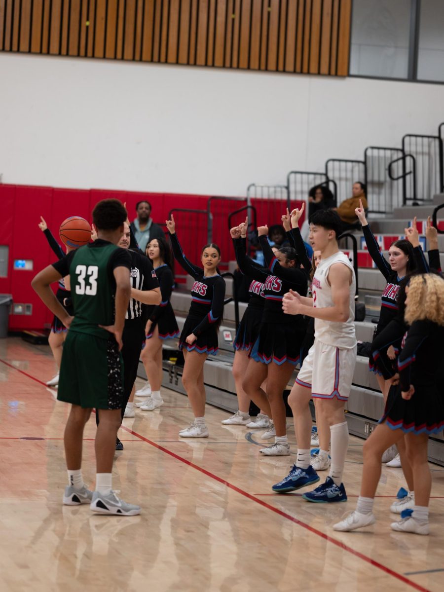 Zhu takes an in-bound pass as the cheer squad chants “you’re the number one.” He scans downcourt for an open pass.