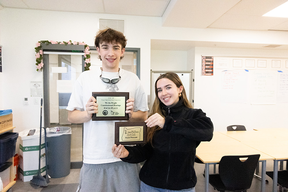 Con team members Emmett Letson and Lenore Halstead pose with the state plaques. The awards are kept safely in AP Gov teacher Amanda Alonso's room. 