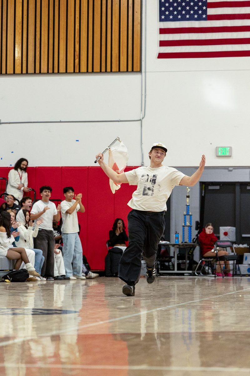 Spirit commissioner Henry Folkerth flys the classic McDaniel M flag at the 2026 Winter Pep Assembly. Folketh plans his own entrances at assemblies, often featuring an announcer. 