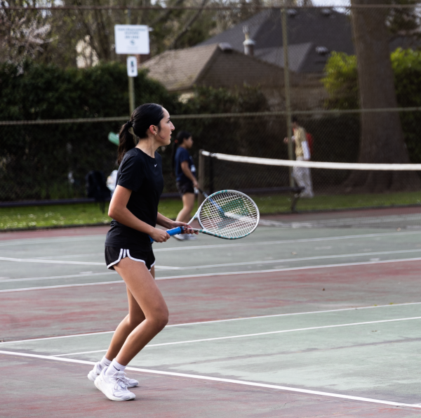 Junior Natalia Fernandez watches McNary’s pair receive the ball after serving them the ball. She is confident that her doubles partner Sanchez will be ready to make a 