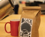 Sam Kilburn prepares her coffee in a bright red mug. Maurice's black coffee sits next to the kettle and cup. 