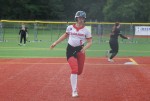 Senior Kaylie Schmitz hustles hard to third base on a hit by one of her teammates. Schmitz ended up being safe but was unable to score in this moment against Roosevelt, but the Mountain Lions won the May 13 game, 9-8.